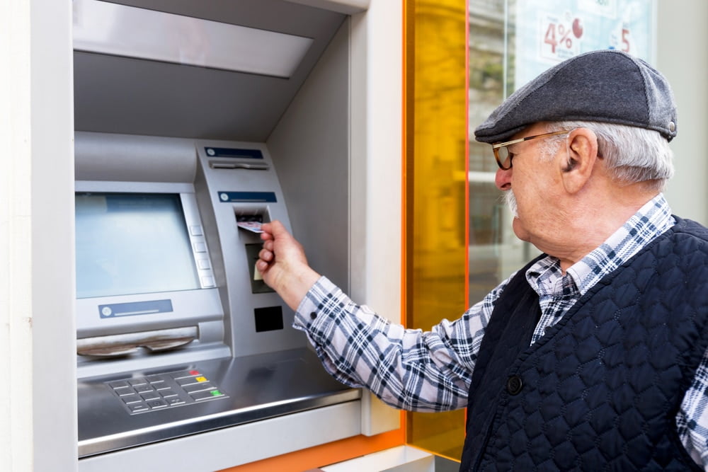 Senior withdrawing money from an ATM
