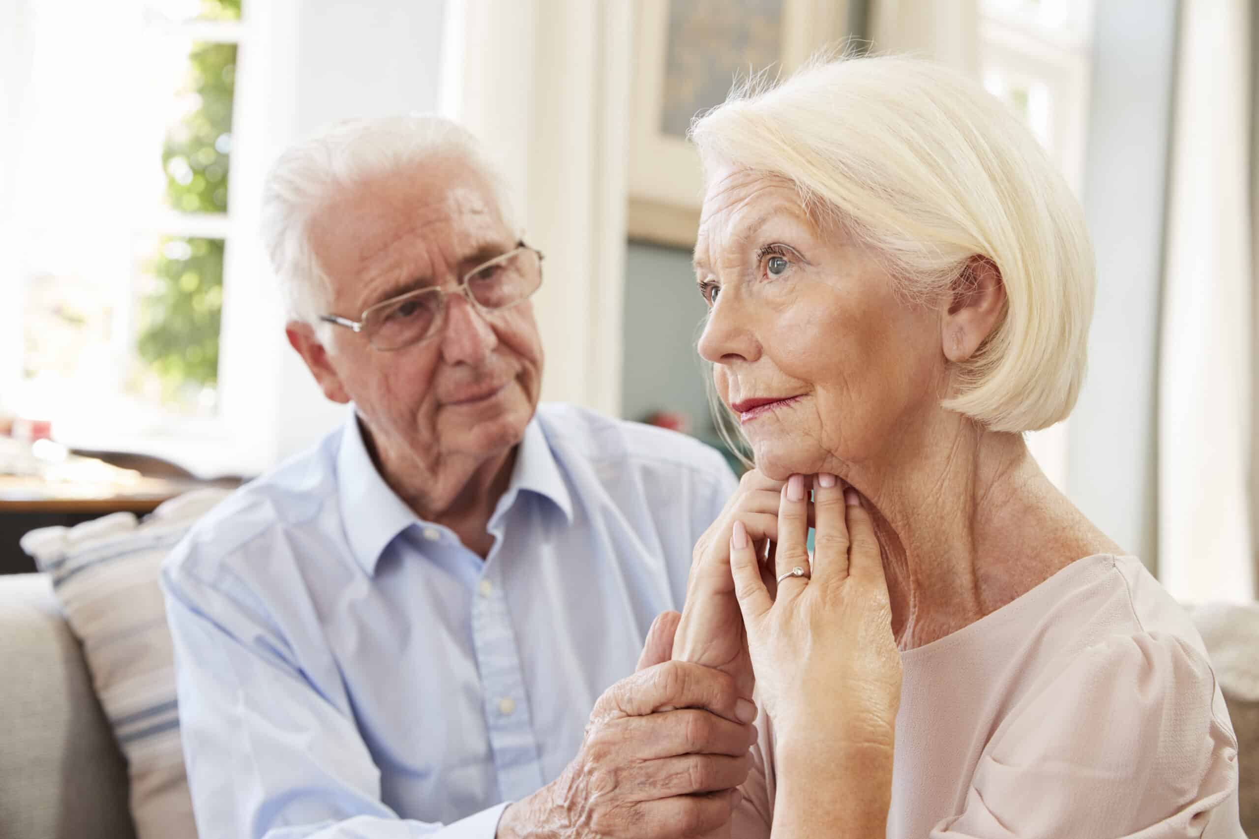 Senior Man Comforting Woman with Dementia at Home